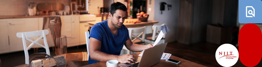 sitting in front of his laptop with a paper in his hand Taking the A+ Certification Exams in New Jersey